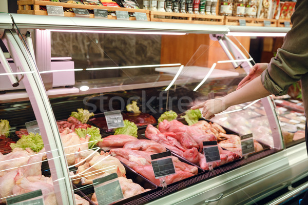 Cropped image of couple choosing meats Stock photo © deandrobot