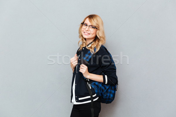 Cheerful young lady student with backpack Stock photo © deandrobot
