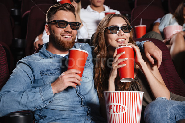 Concentrated loving couple friends sitting in cinema Stock photo © deandrobot