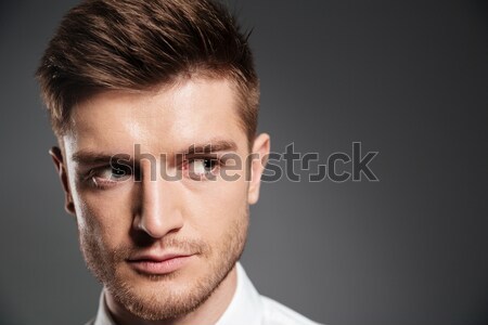 Confident serious man in shirt looking away at copy space Stock photo © deandrobot