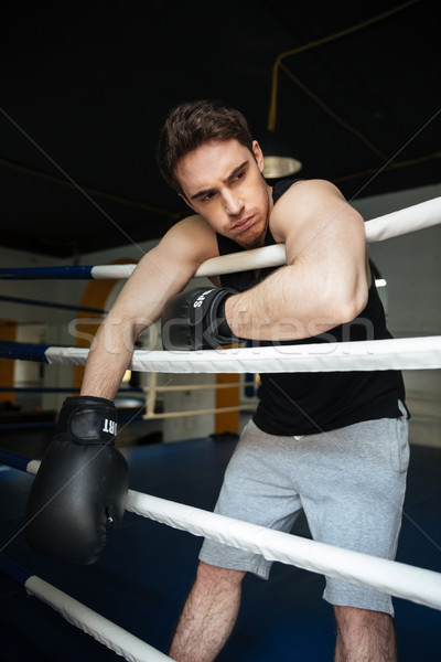 Boxer training in a boxing ring. Looking aside. Stock photo © deandrobot