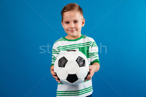 Stock photo: Portrait of a smiling kid holding soccer ball