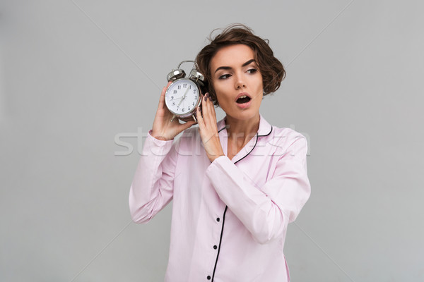 Portrait of a young shocked girl in pajamas Stock photo © deandrobot