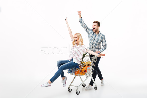 Full length portrait of a joyful couple having fun Stock photo © deandrobot