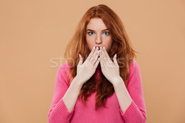 Close up portrait of a shocked young redhead girl Stock photo © deandrobot