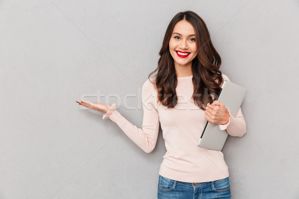 Photo of gorgeous female student studying in college using silve Stock photo © deandrobot