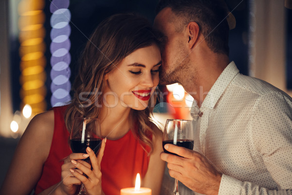 Jóvenes hombre guapo susurro mujer romántica cena Foto stock © deandrobot