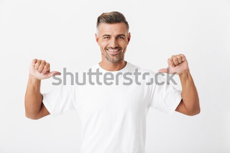 Young happy man showing thumbs up. Stock photo © deandrobot
