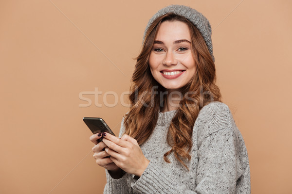 Close-up photo of young smiling brunette woman in warm clothes u Stock photo © deandrobot