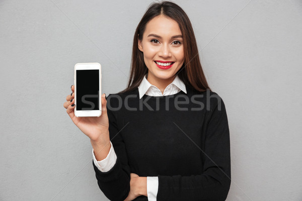 Sorridente asiático mulher negócio roupa Foto stock © deandrobot
