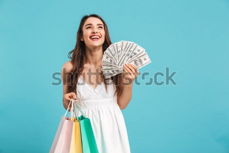 Portrait of excited female shopaholic standing with lots of pack Stock photo © deandrobot