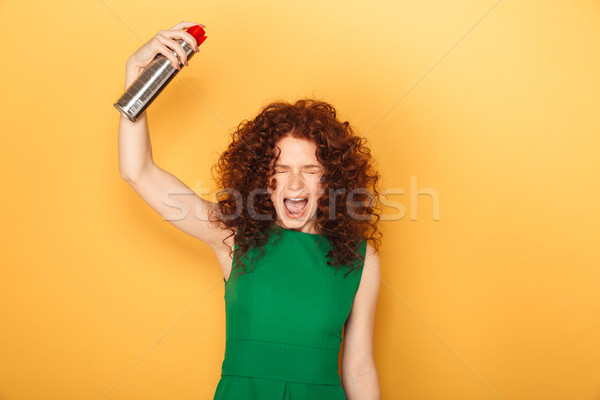 Portrait of a cheerful curly redhead woman Stock photo © deandrobot