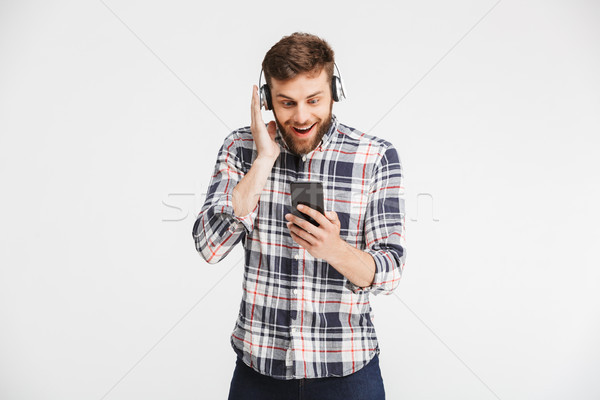 Portrait of a happy young man in plaid shirt Stock photo © deandrobot