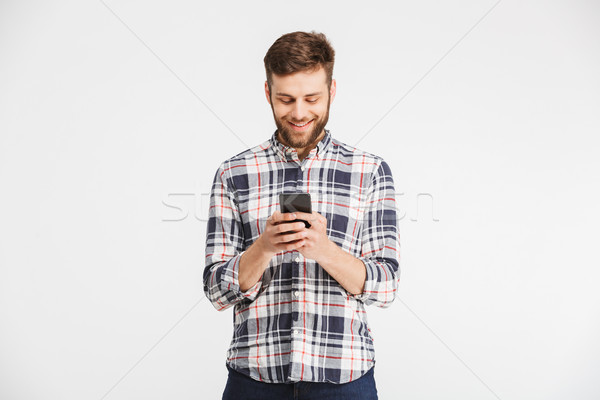 Portrait of a happy young man in plaid shirt Stock photo © deandrobot