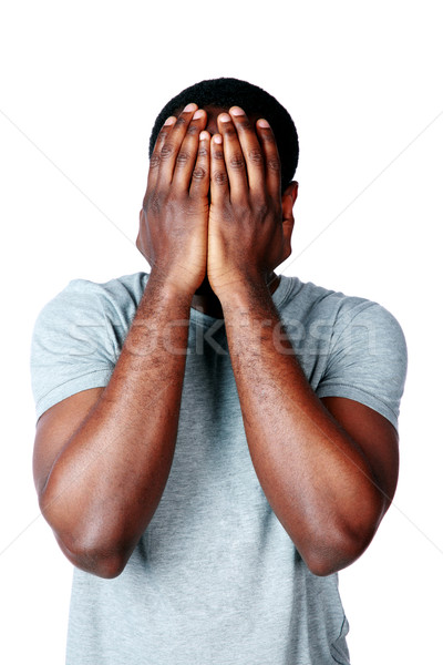 Portrait of a depressed african man over white background Stock photo © deandrobot