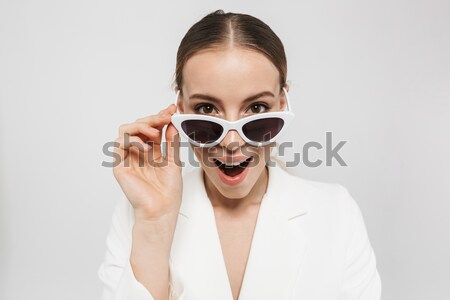 Laughing man with curly hair and sunglasses on a white backgorund Stock photo © deandrobot