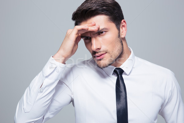 Retrato empresário dor de cabeça cinza fundo camisas Foto stock © deandrobot