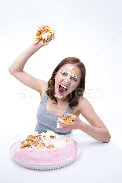 Angry young woman wants to throw cake into the camera Stock photo © deandrobot