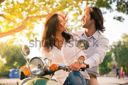 Candid shot of a young couple bonding together outdoors Stock photo © deandrobot