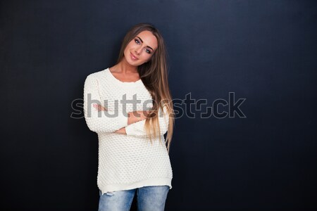 Smiling attractive girl standing with arms folded Stock photo © deandrobot