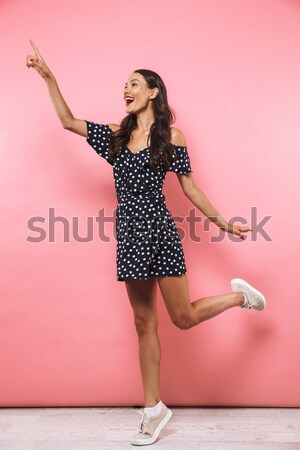 Woman in dress sitting on modern chair Stock photo © deandrobot