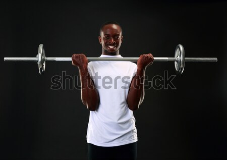 Stock photo: Close-up portrait of fitness girl doing squats with barbell