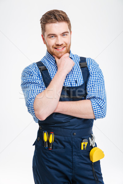 Happy thoughtful male builder looking at camera Stock photo © deandrobot