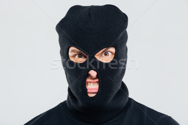 Supărat agresiv tânăr om masca Imagine de stoc © deandrobot