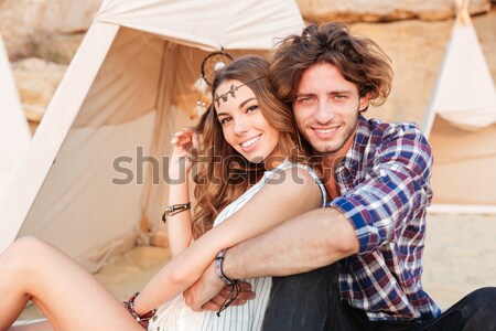 Couple sitting and embracing on porch of the house Stock photo © deandrobot
