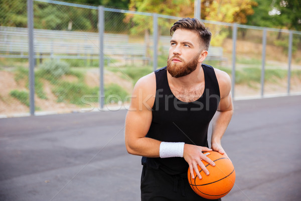 Portrait of a young sports man playing basketball Stock photo © deandrobot