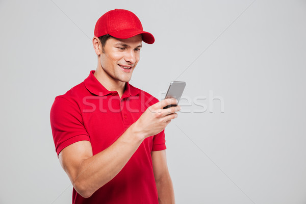 Stock photo: Courier looking at phone