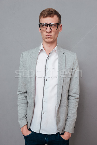 Young man in suit and glasses Stock photo © deandrobot