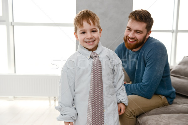 Little cute boy dressed in father's clothes Stock photo © deandrobot