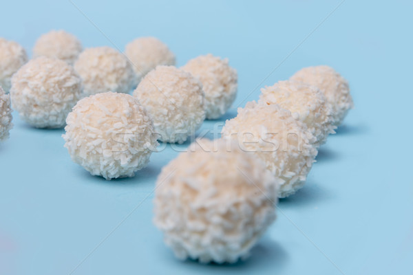 Coconut sweeties candy over blue table background. Stock photo © deandrobot