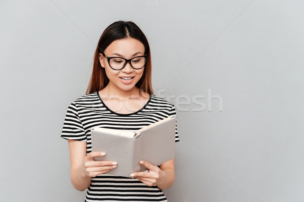 Hardworking student woman reading book isolated Stock photo © deandrobot