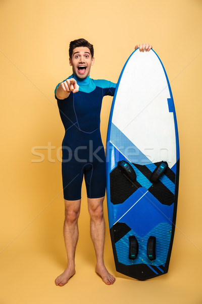 Full length portrait of a cheerful young man Stock photo © deandrobot