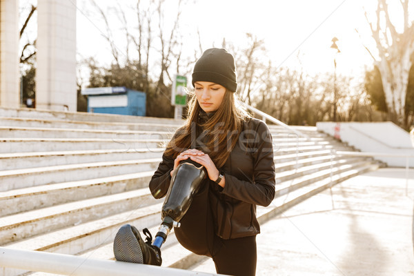 Image of handicapped sportswoman in black tracksuit, training an Stock photo © deandrobot