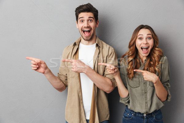 Portrait of a happy young couple standing together Stock photo © deandrobot