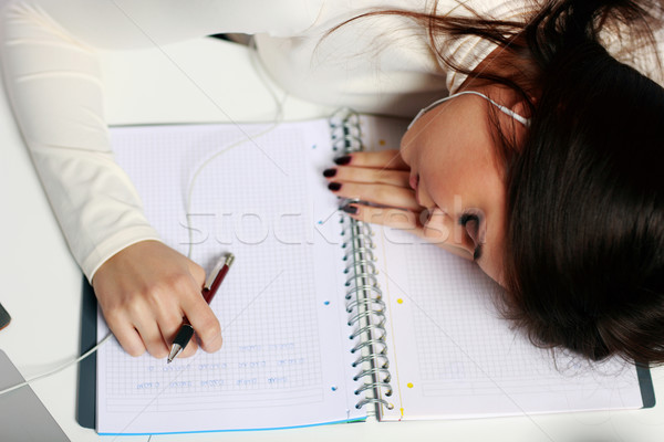 Young tired student fallen asleep at the table Stock photo © deandrobot