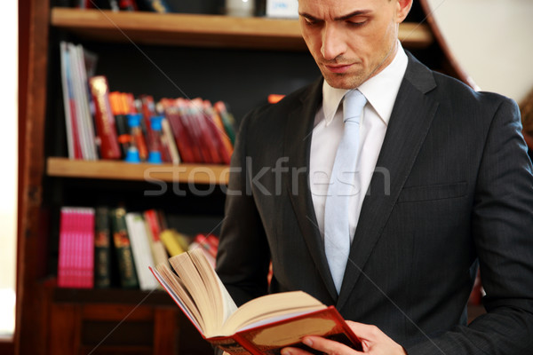 Businessman reading the book in library Stock photo © deandrobot