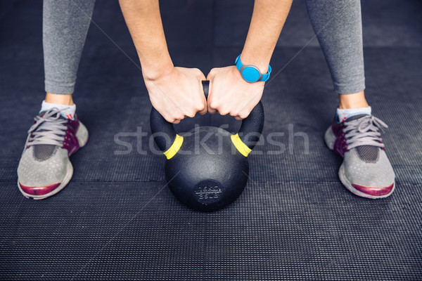 Woman working out with kettle ball Stock photo © deandrobot