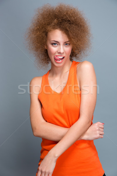 Curly seductive flirty girl showing tongue Stock photo © deandrobot