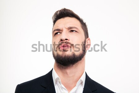 Portrait of pensive attractive young man thinking and looking up Stock photo © deandrobot