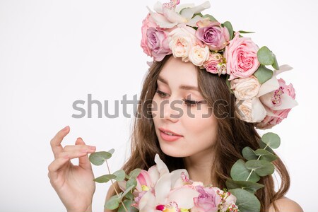 Stock photo: Happy charming young female in roses wreath holding beautiful bouquet