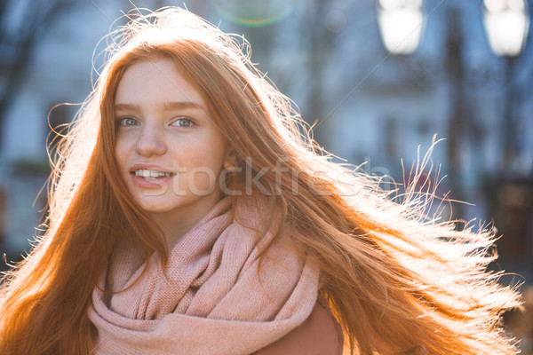 Woman with long redhead hairs standing outdoors Stock photo © deandrobot