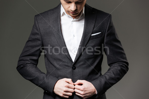 Handsome young businessman in black suit and white shirt  Stock photo © deandrobot