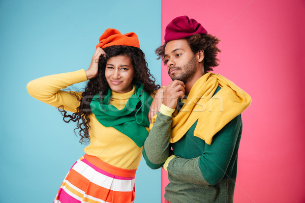 Sad tired african american young couple in hats and scarves Stock photo © deandrobot