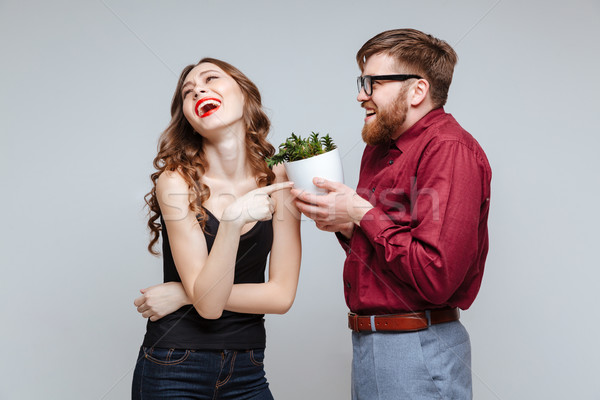 Male nerd presents the plant for girl Stock photo © deandrobot