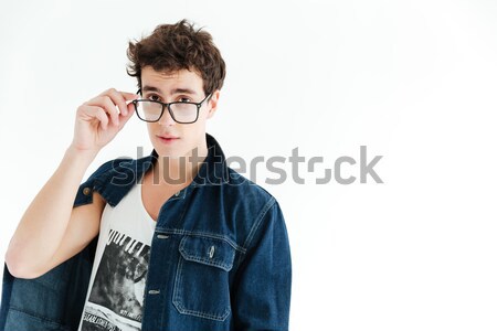 Hipster in eyeglasses looking at the camera Stock photo © deandrobot