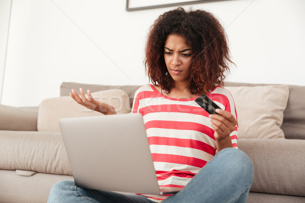 молодые путать расстраивать женщину используя ноутбук домой Сток-фото © deandrobot